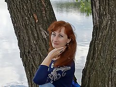 A beautiful mature woman is fondling her genital area